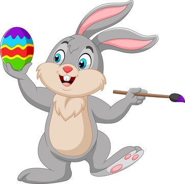 Cartoon rabbit painting an Easter egg