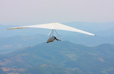 Hang glider pilot in Italian mountains
