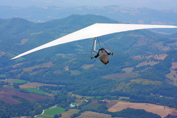 Hang glider pilot in Italian mountains