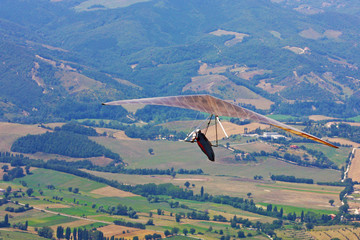 Hang glider pilot in Italian mountains