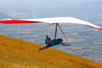 Hang glider pilot in Italian mountains