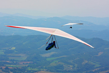 Hang glider pilot in Italian mountains
