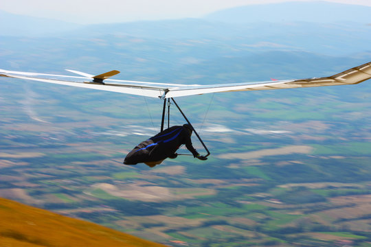 Hang glider pilot in Italian mountains