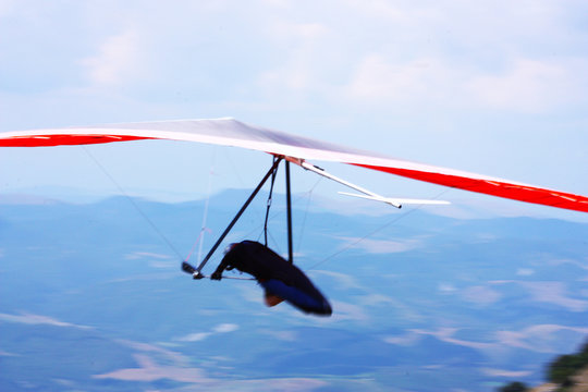 Hang glider pilot in Italian mountains