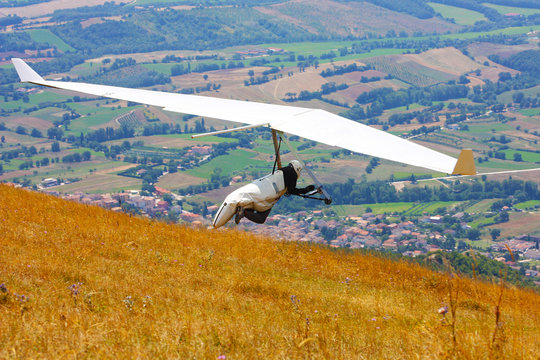 Hang glider pilot in Italian mountains