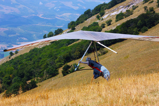Hang glider pilot in Italian mountains