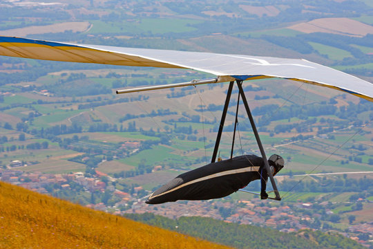 Hang glider pilot in Italian mountains