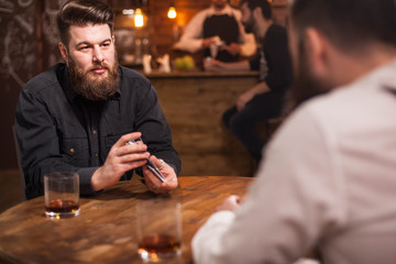Attractive bearded men drinking whiskey in a pub