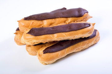 Eclairs with custard inside on a white background. homemade baking
