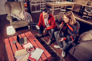 Fototapeta premium Modern talented musicians using gadgets while composing new song