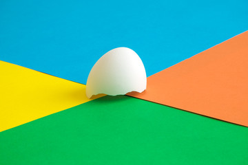 Flat lay of eggshell on multicolored background abstract.