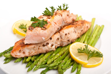 healthy salmon with coriander garnished with asparagus and lemon