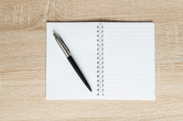 pen and flash drive and Notepad on wooden background