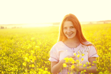 Naklejka na ściany i meble redhead woman outdoors. stylish romantic young girl on nature background. yellow field