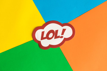 Lol text in speech bubble against multicolored background abstract.
