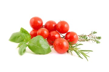 Tomatoes with basil, rosemary and thyme isolated on white. Cherry tomato and herb.