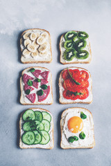 Set of sandwich with tomatoes, cucumbers, bananas, kiwi, egg and meat top view