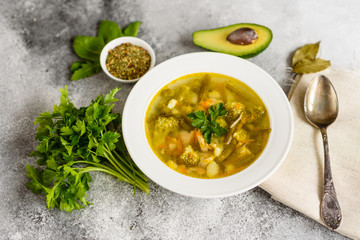 Tasty vegetables and spices soup on a gray concrete background. It can be used as a background