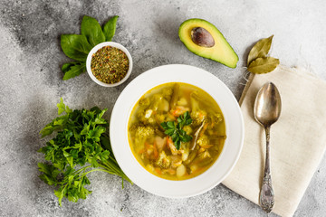 Tasty vegetables and spices soup on a gray concrete background. It can be used as a background