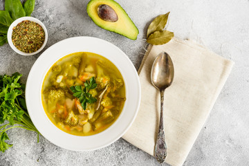 Tasty vegetables and spices soup on a gray concrete background. It can be used as a background