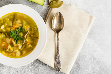 Tasty vegetables and spices soup on a gray concrete background. It can be used as a background