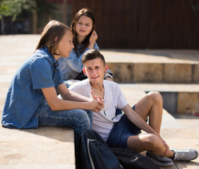 teenagers communicate in schoolyard