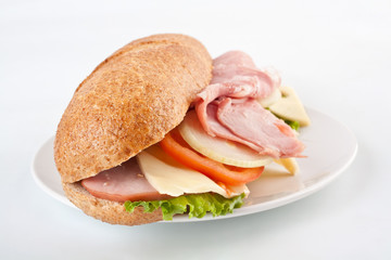 sub bran baguette  sandwich with ham, cheese, lettuce and tomatoes