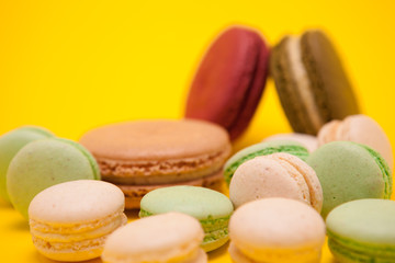 French delicious macaroons dessert over yellow background