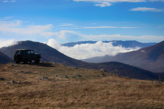 Travel by car in the mountains on par with clouds