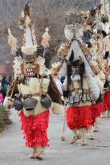 Fototapeta premium Zemen, Bulgaria - March 16, 2019: Masquerade festival Surva in Zemen, Bulgaria. People with mask called Kukeri dance and perform to scare the evil spirits.