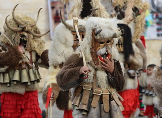 Obraz premium Zemen, Bulgaria - March 16, 2019: Masquerade festival Surva in Zemen, Bulgaria. People with mask called Kukeri dance and perform to scare the evil spirits.