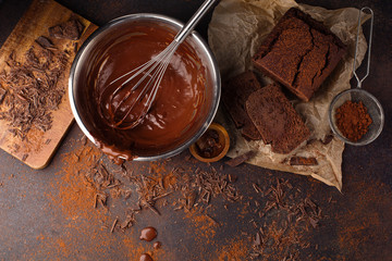 Homemade chocolate cake and cream with whisk