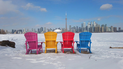 View of Toronto city skyline seen form Toronto Islands with colourful chairs
