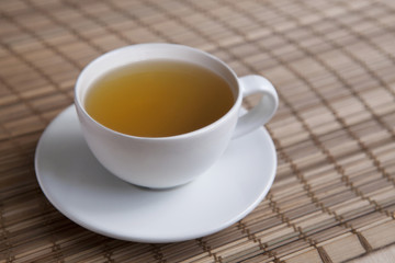 Green tea on a brown mat close-up