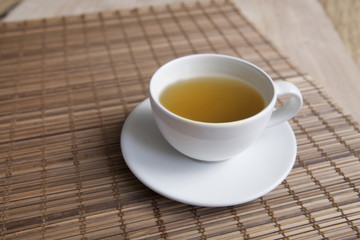 Green tea on a brown mat close-up