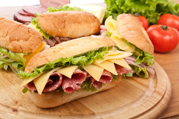group of tasty ham, salami, turkey and beef sandwiches