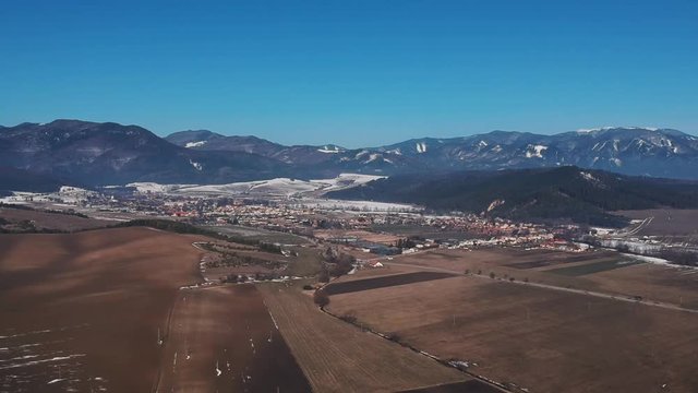 Aerial drone footage going towards Klastor pod Znievom village in the Žilina Region of northern Slovakia, near the Mal&aacute; Fatra mountains in winter