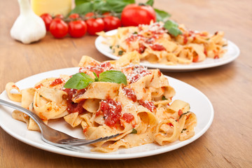 tasty pappardelle pasta with tomato marinara sauce and ingredients 