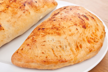 two calzone pizza on a plate