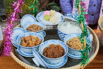 Khao Chae (rice in iced water with Jasmine flower) traditional Mon food  and many dessert in the plate.