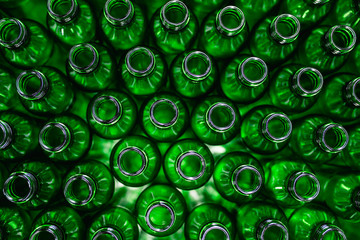 Bottling plant - Water bottling line for processing and bottling pure spring water into green glass bottles. Selective focus.