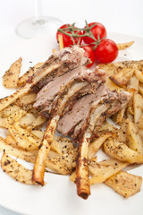 roasted spicy lamb rack of ribs and potatoes 