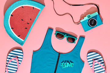Fashion Summer Hipster Clothes Accessories coral Set. Film Camera, Glamor Clutch, Trendy flip flops, fashion flat lay. Urban beach Outfit. Hot summertime color. Creative Bright fashionable Style