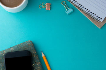 Template for social media - work space, work table. Smartphone with open notebook, coffee cup and office supplies. Space for text. Flat lay, copy space.