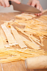 cutting uncooked homemade egg pasta