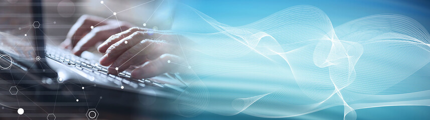 Hands using a laptop, hard light effect, overlayed with graphs. panoramic banner