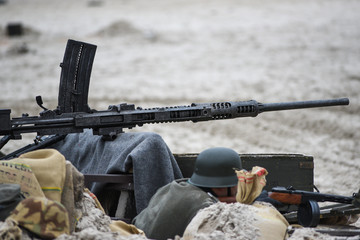 Barrel of a machine gun from WWII during the reconstruction of the battle