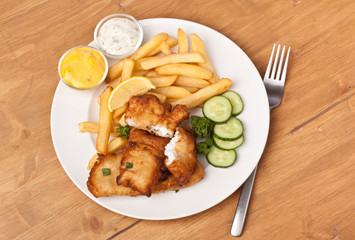 Serving of Fish and Chips on a wooden table