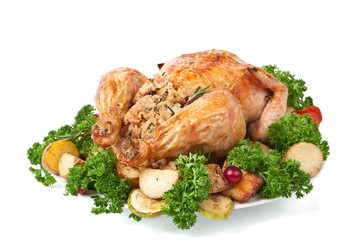 whole roasted stuffed chicken with parsley, vegetables and cranberries