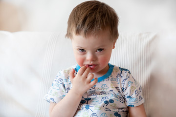 Portrait of cute small boy with Down syndrome